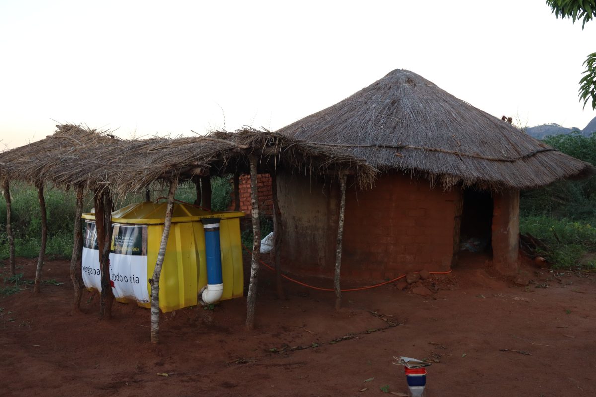 A SPARK digester installed beside a thatched home in Manica, Mozambique